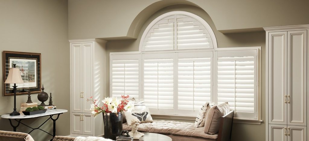 Alta custom shutters covering both rectangular and half-round windows. 